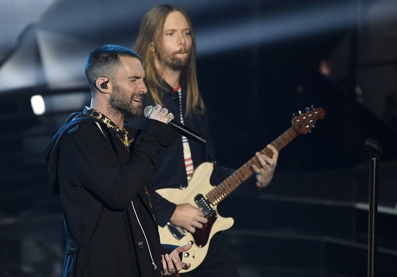 FILE - In this Sunday, March 11, 2018 file photo, Adam Levine, left, and James Valentine of Maroon 5 perform during the 2018 iHeartRadio Music Awards at The Forum in Inglewood, Calif. Maroon 5 has canceled its news conference to discuss the band's Super Bowl halftime performance, choosing to not meet with reporters as most acts have done during the week leading up to the NFL's big game. The NFL announced Tuesday, Jan. 29, 2019 that "the artists will let their show do the talking as they prepare to take the stage this Sunday." (Photo by Chris Pizzello/Invision/AP, File)

