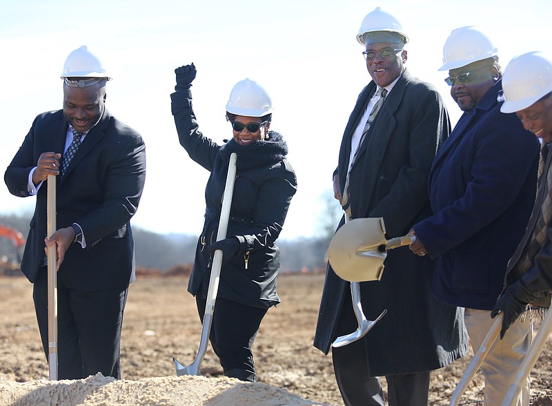 The Howard School principal Le Andrea Ware, second from the left, throws a fist in the air in celebration after tossing sand for a groundbreaking photo following the event at Howard School Thursday, January 31, 2019 in Chattanooga, Tennessee. Construction is underway for a new stadium and track at the school.