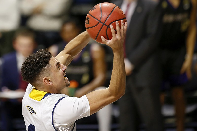 Staff photo by C.B. Schmelter / UTC's Jonathan Scott drives to the basket during a home game against Western Carolina in January.