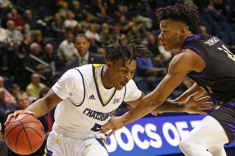 UTC guard Donovann Toatley (5) works against Western Carolina guard Marcus Thomas (21) during a Southern Conference basketball game at McKenzie Arena on Thursday, Jan. 31, 2019 in Chattanooga, Tenn.