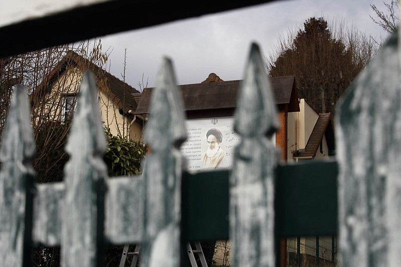 In this photo taken on Tuesday, Jan. 29, 2019, a view of the entrance gate to Rue de Chevreuse, close to the cottage which served as Ayatollah Ruhollah Khomeini's operational and media headquarters during his four month stay in October 1978, in Neauphle-Le-Chateau, west of Paris. Sheltered in a cottage in a sleepy village outside Paris, Ayatollah Ruhollah Khomeini piped out messages daily to hundreds of followers clamoring to glimpse their glowering idol with black turban, and amplified his pronouncements with recorded messages to Iranians at home, turning his humble abode into an international megaphone for the Islamic revolution. (AP Photo/Francois Mori)