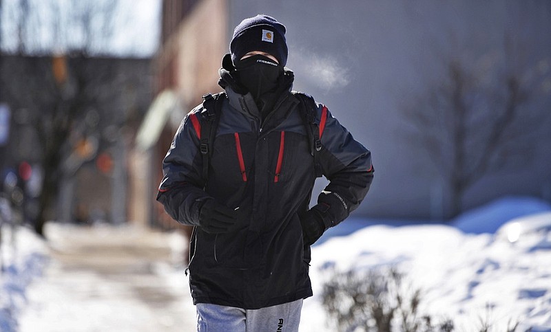 A pedestrian is covered in his winter wardrobe while walking on Franklin Avenue on a brutally cold Thursday, Jan. 31, 2019, in downtown Scranton, Pa. (Butch Comegys/The Times-Tribune via AP)