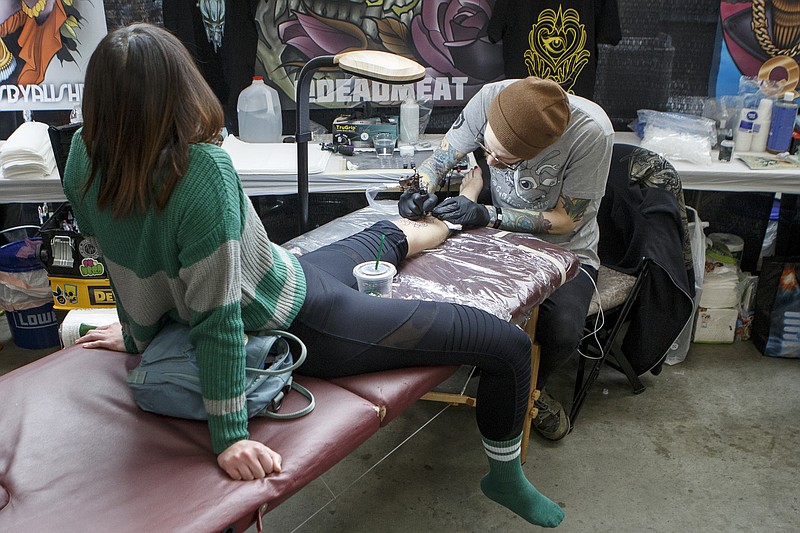 Nick Keiser, right, tattoos Sandy baker during Literary Ink: The Convention of Secrets tattoo convention at the Chattanooga Convention Center on Friday, Feb. 1, 2019 in Chattanooga, Tenn. The Harry Potter-themed tattoo convention, in its second year, will continue Saturday and Sunday.