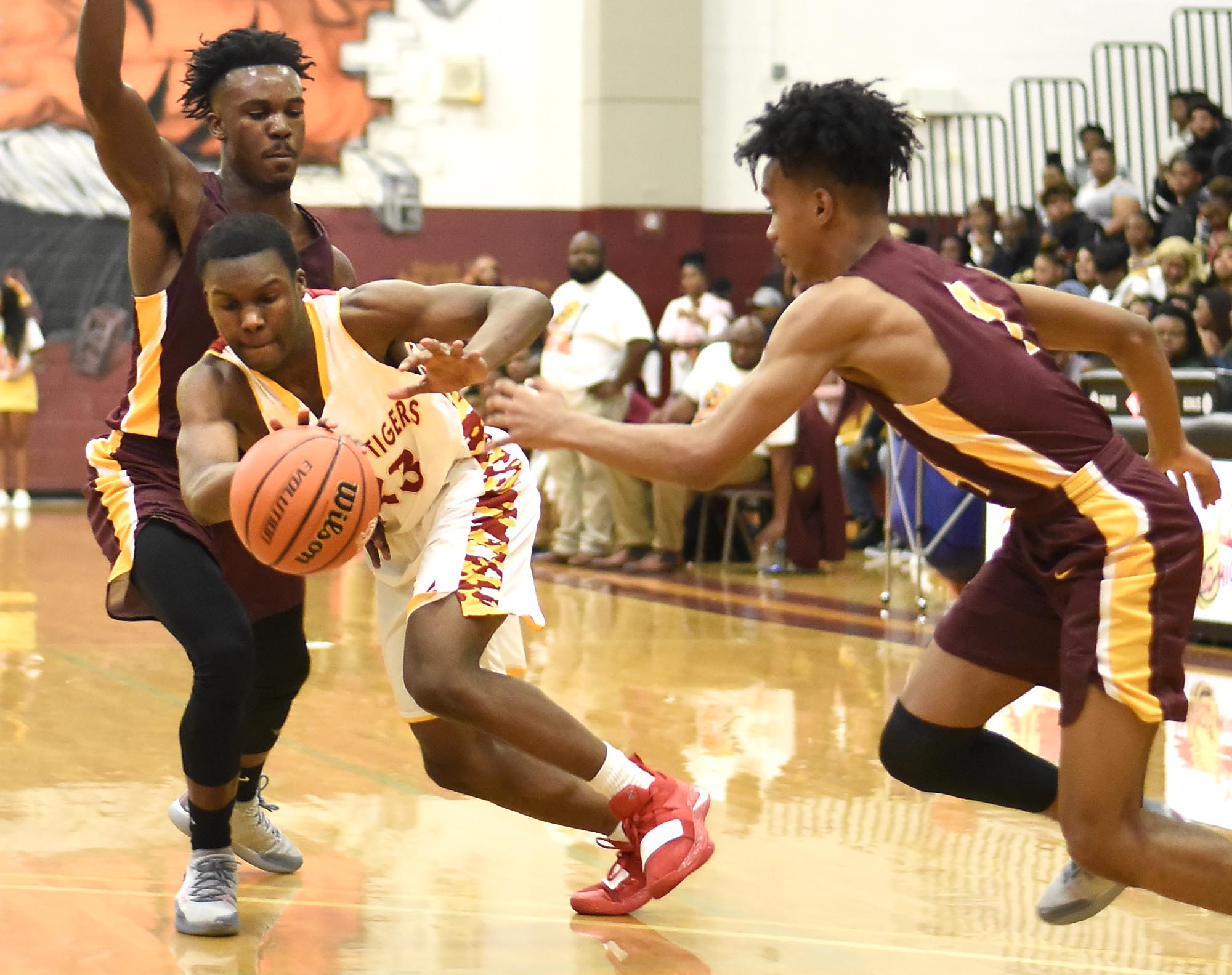 Howard's Calvin James (23) tries to dribble out from under the pressure of Tyner's Amon Grace (22) and Kameron Dozier (4). The Tyner Rams visited the Howard Hustling Tigers in TSSAA boys' basketball on February 1, 2019.