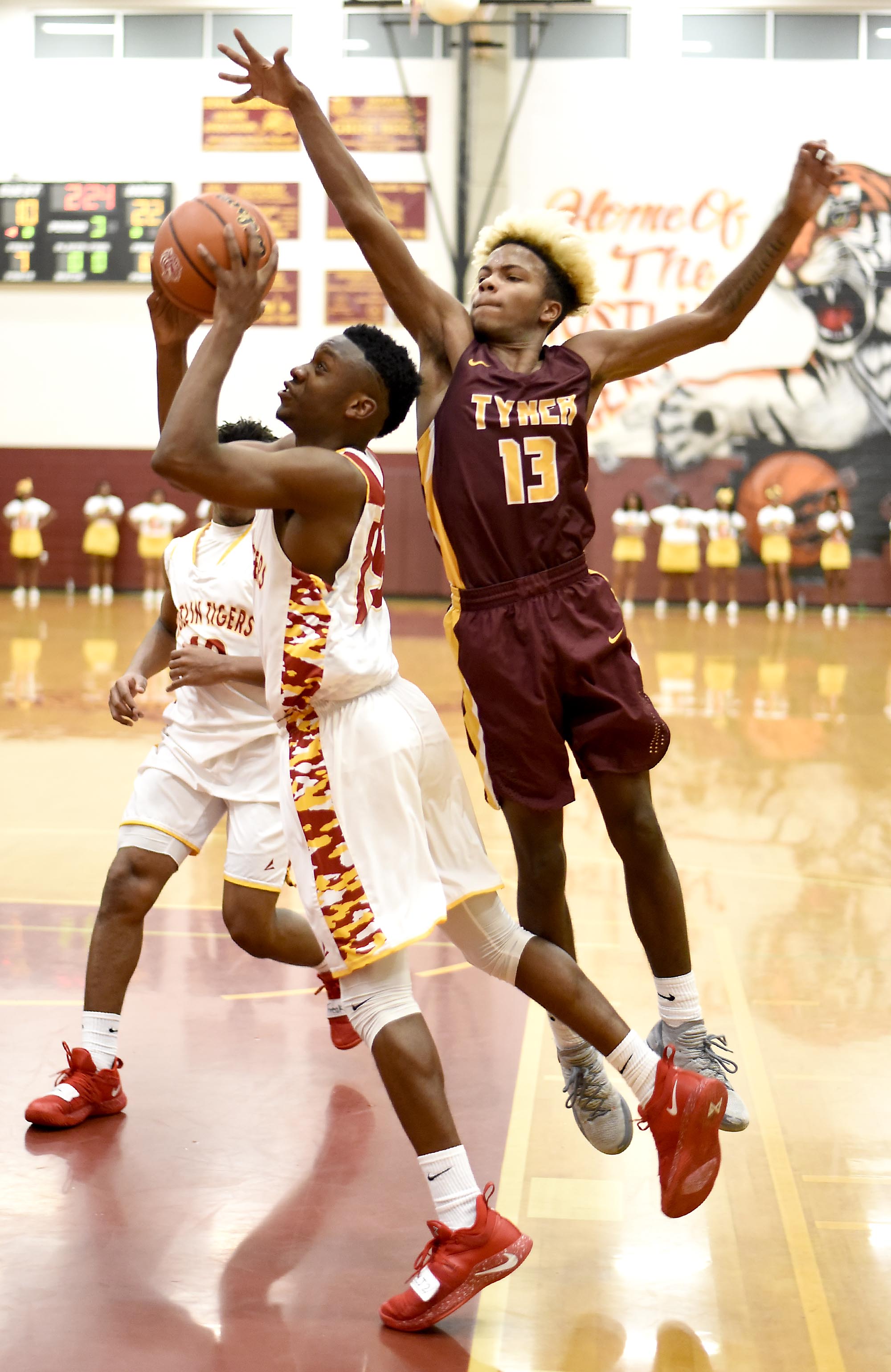 Howard's Ruben Snow (15) drives to the basket past Tyner's Xavier Fisher (13). The Tyner Rams visited the Howard Hustling Tigers in TSSAA boys' basketball on February 1, 2019.