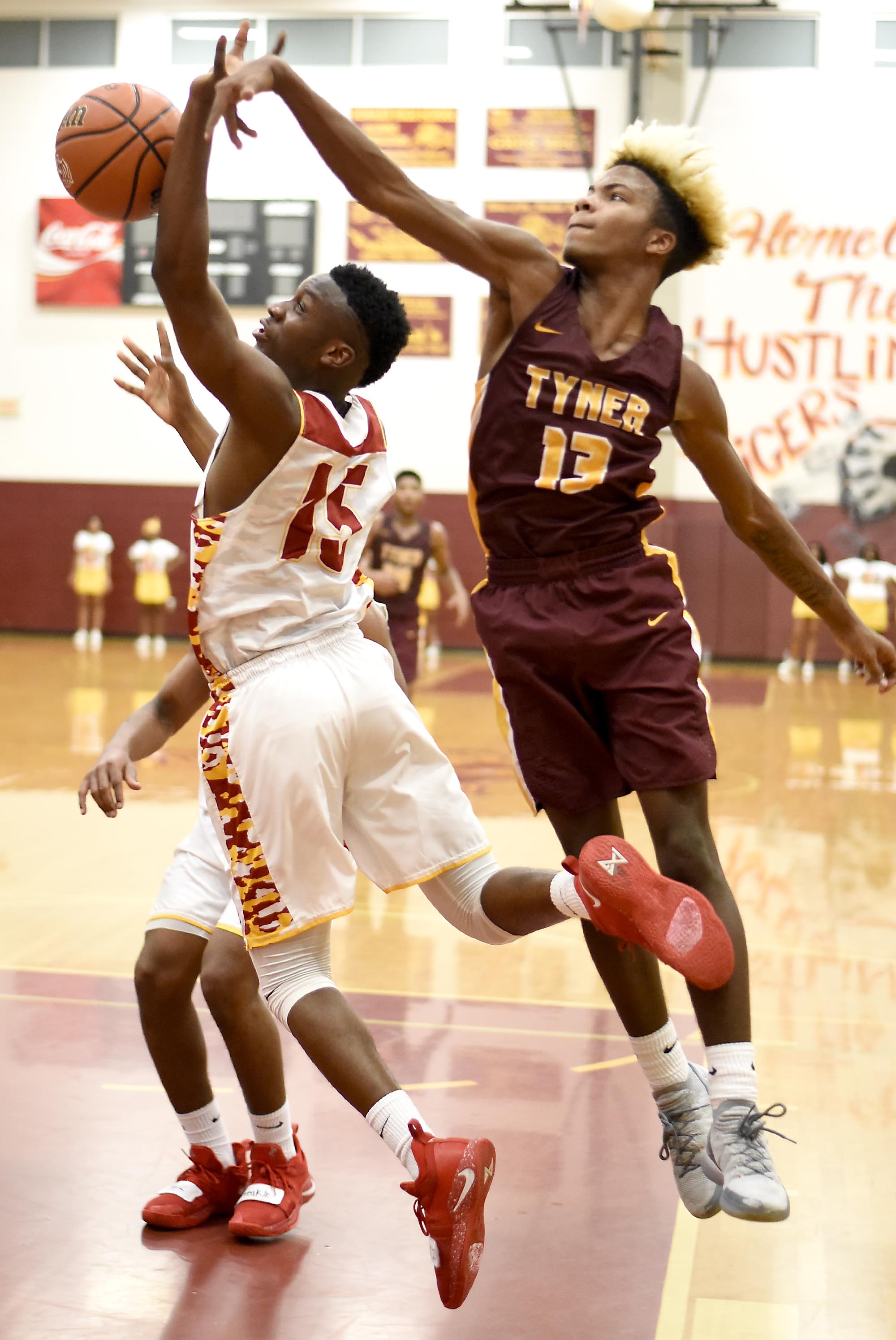 Tyner's Xavier Fisher (13) blocks the shot of Howard's Ruben Snow (15). The Tyner Rams visited the Howard Hustling Tigers in TSSAA boys' basketball on February 1, 2019.