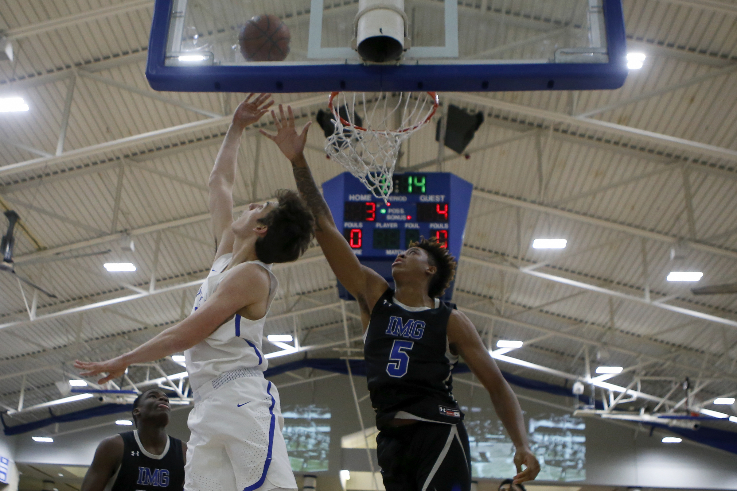 McCallie's Neill Dickey (0) puts up a shot against IMG Academy's Armando Bacot (5) during The McCallie Dr Pepper TEN Classic at the Walker Forum on the campus of the McCallie School on Friday, Feb. 1, 2019 in Chattanooga, Tenn.