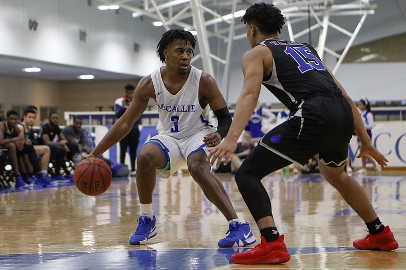 McCallie's Shannon Walker dribbles while guarded by IMG Academy's Max Williams during a Dr Pepper TEN Classic game Friday night at the Walker Forum. McCallie lost 66-49 to the nationally ranked program from Bradenton, Fla.