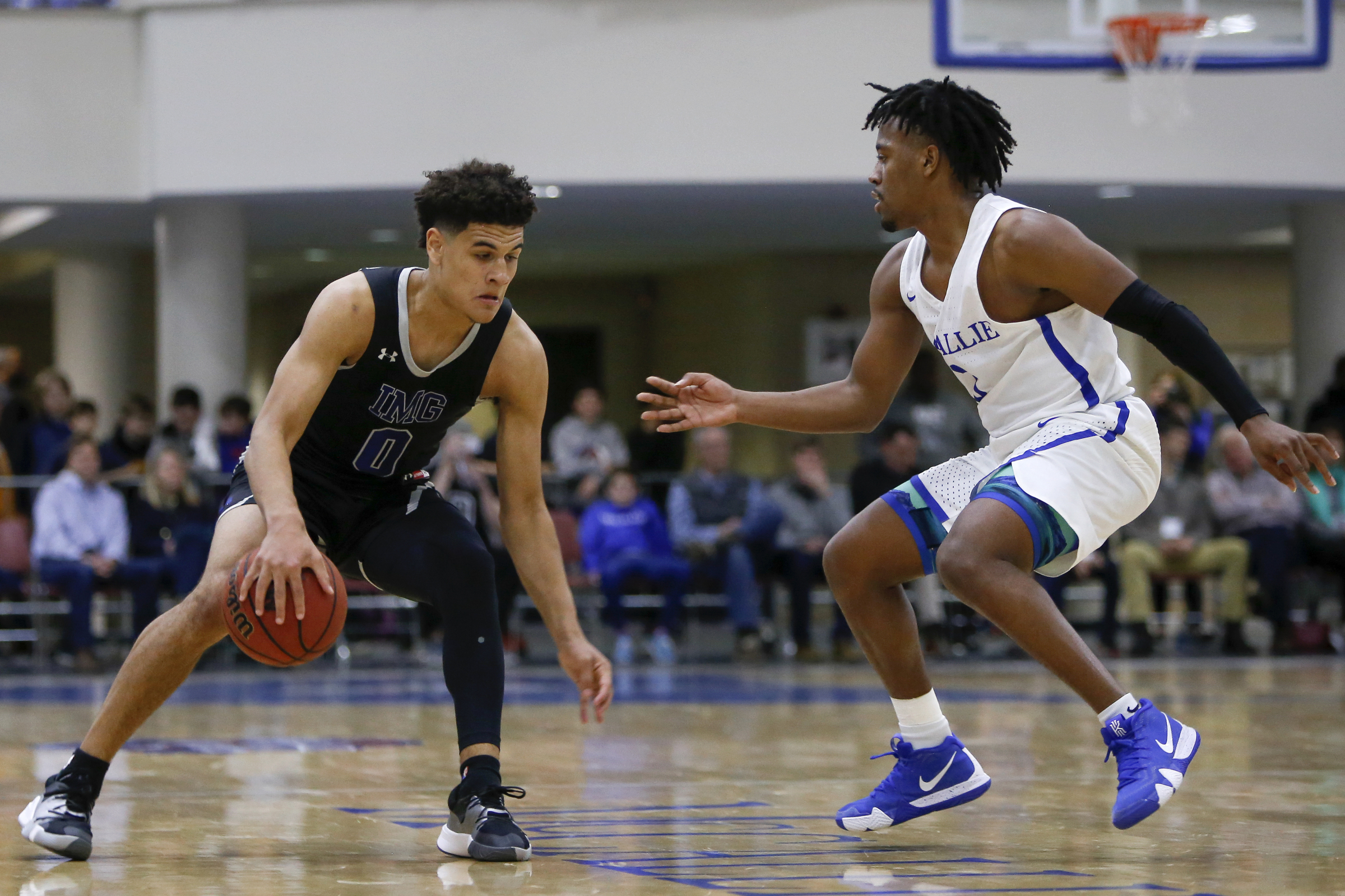 IMG Academy's Josh Green (0) works against McCallie's Shannon Walker (3) during The McCallie Dr Pepper TEN Classic at the Walker Forum on the campus of the McCallie School on Friday, Feb. 1, 2019 in Chattanooga, Tenn.