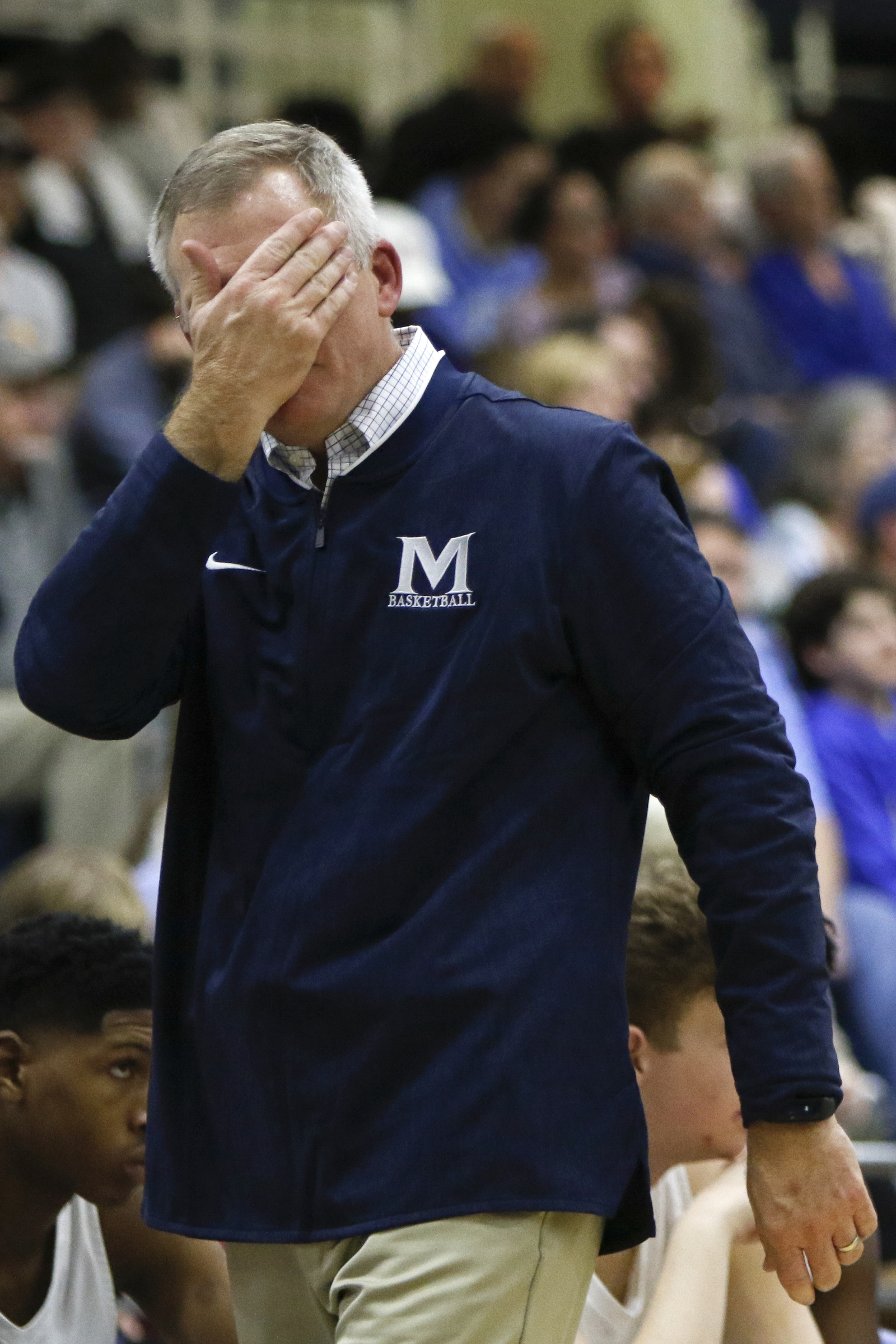 McCallie's coach David Conrady wipes his face during the Blue Tornado's game against IMG Academy during The McCallie Dr Pepper TEN Classic at the Walker Forum on the campus of the McCallie School on Friday, Feb. 1, 2019 in Chattanooga, Tenn.