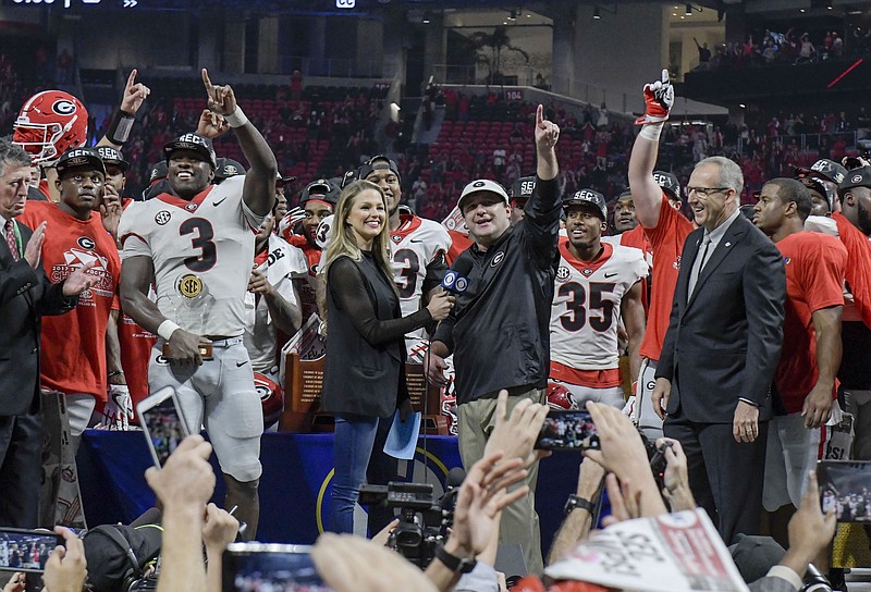 SEC commissioner Greg Sankey, right, looks on as Georgia football coach Kirby Smart celebrates a victory over Auburn in the 2017 league championship game.

