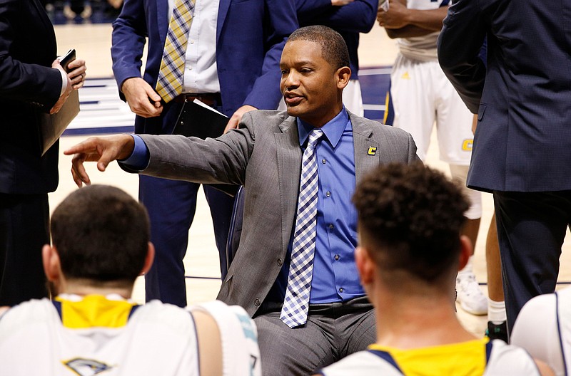 Chattanooga men's basketball coach Lamont Paris speaks with players during a timeout in the Mocs' home basketball game against the ETSU Buccaneers at McKenzie Arena on Saturday, Feb. 2, 2019, in Chattanooga, Tenn. 