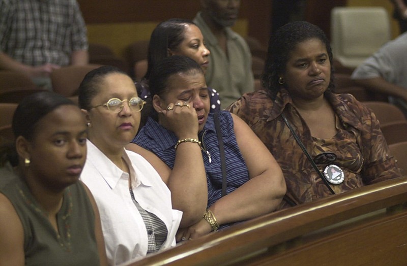 Family members of Buckhead double murder victims Richard Lollar and Jacinth Baker react as "not guilty" verdicts are read in Fulton Superior Court in the trial of Joseph Sweeting and Reginald Oakley on June 12, 2000, in Atlanta. From left are Charita Lollar, Richard Lollar's cousin; Vondie Boykin, Jacinth Baker's aunt; Thomasaina Threatt, Lollar's aunt; and Faye Lollar, Lollar's aunt.