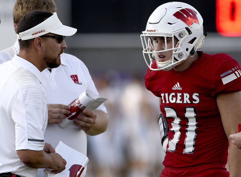 Whitwell High School football player Hudson Petty talks with coach Randall Boldin during a jamboree game in August. Petty was a Mr. Football semifinalist last season, when he was MVP of the Tigers' Class 1A state title victory.