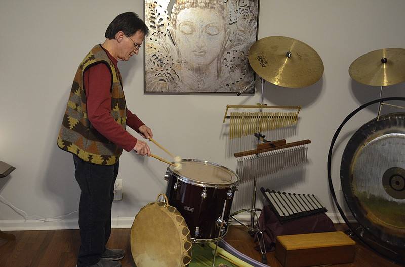 Sound healer Mario Aranda plays a drum at Spiral Garden Wellness Center.