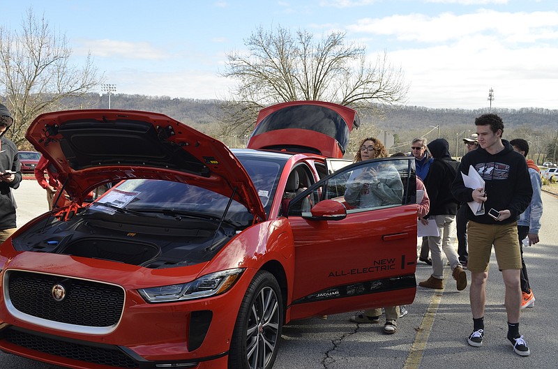 Ooltewah High School students study the design elements of a 2019 Jaguar I-PACE EV400 First Edition, one of three cars brought to the school by the local Jaguar, Land Rover and Porsche dealership to demonstrate connection between cars and fashion.