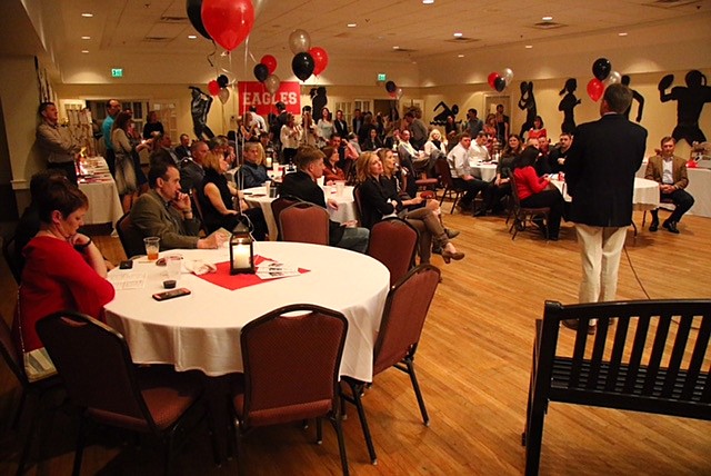 Attendees prepare to bid on live auction items at last year's Red & Black Auction benefiting Signal Mountain Middle/High School sports teams. (Contributed photo)