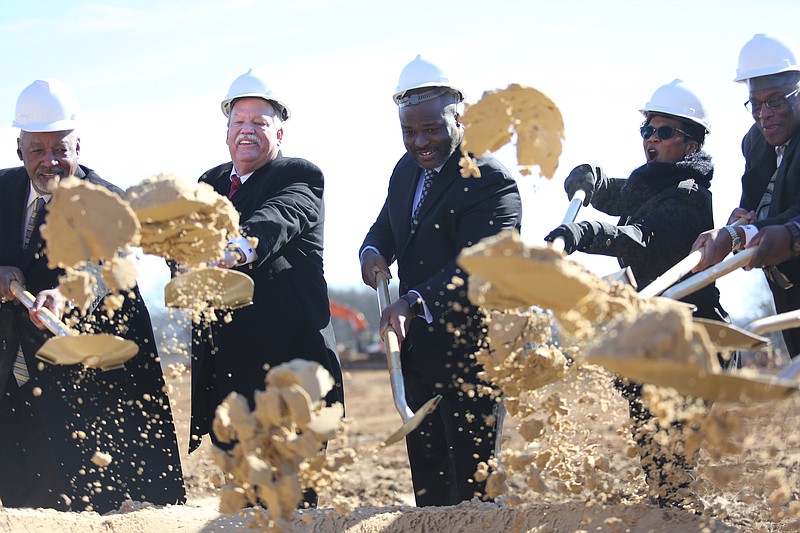 Former District 5 County Commissioner Greg Beck, left, joins others in breaking ground for a new stadium and track at The Howard School last week.