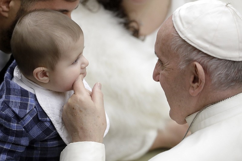 Pope Francis plays with a baby during the weekly general audience he held in the Pope Paul VI hall, at the Vatican, Wednesday, Jan. 30, 2019. (AP Photo/Andrew Medichini)

