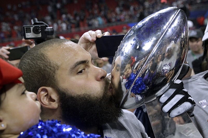 New England Patriots' Lawrence Guy kisses the trophy after the NFL Super Bowl 53 football game against the Los Angeles Rams, Sunday, Feb. 3, 2019, in Atlanta. The Patriots won 13-3. (AP Photo/Patrick Semansky)

