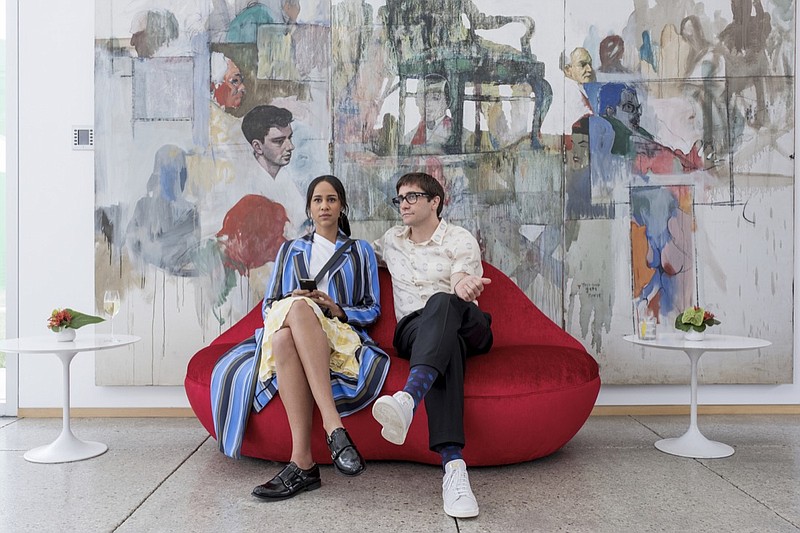 This image released by Netflix shows Zawe Ashton, left, and Jake Gyllenhaal in a scene from "Velvet Buzzsaw." (Claudette Barius/Netflix via AP)