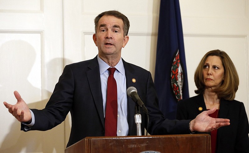 In this Feb. 2, 2019, photo, Virginia Gov. Ralph Northam, left, accompanied by his wife, Pam, speaks during a news conference in the governor's mansion in Richmond, Va. Democrats are hoping there's a silver lining to the Northam mess - that it shows they won't tolerate racism. Every level of the party has condemned the Democratic Virginia governor and demanded he step down. That follows disclosure that his medical school yearbook page features photos of a man in blackface standing with someone dressed in Klu Klux Klan attire.(AP Photo/Steve Helber)