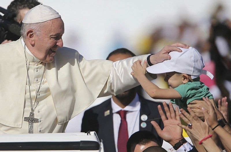 Pope Francis blesses a boy during a Mass at the Sheikh Zayed Sports City in Abu Dhabi, United Arab Emirates, Tuesday, Feb. 5, 2019. Francis travelled to Abu Dhabi to participate in a conference on inter religious dialogue sponsored the Emirates-based Muslim Council of Elders, an initiative that seeks to counter religious fanaticism by promoting a moderate brand of Islam. (AP Photo/Kamran Jebreili)