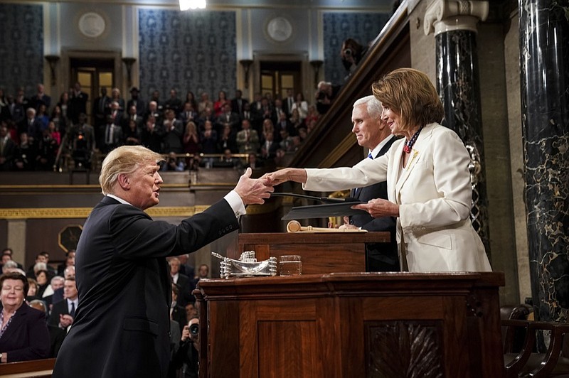 President Donald Trump shakes hands with House Speaker Nancy Pelosi as Vice President Mike Pence looks on, as he arrives in the House chamber before giving his State of the Union address to a joint session of Congress, Tuesday, Feb. 5, 2019 at the Capitol in Washington. (Doug Mills/The New York Times via AP, Pool)

