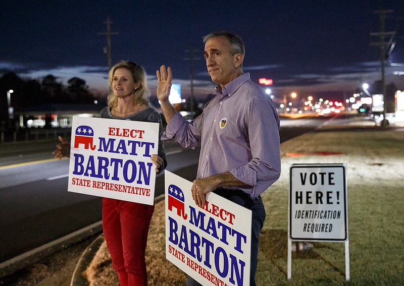 Staff photo by Doug Strickland / Georgia State House District 5 candidate Matt Barton, right, and his wife Lynne wave to vehicles while standing outside Belmont Baptist Church on Tuesday, Feb. 5, 2019, in Calhoun, Ga. Barton and opponent Jesse Vaughn sought to replace State Rep. John Meadows, who died in November, in Tuesday's special election runoff.