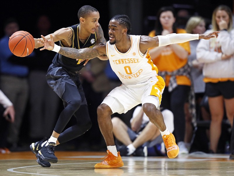 Tennessee guard Jordan Bone (0) attempts to steal the ball from Missouri guard Xavier Pinson (1) during the first half of an NCAA college basketball game Tuesday, Feb. 5, 2019, in Knoxville, Tenn. (AP photo/Wade Payne)

