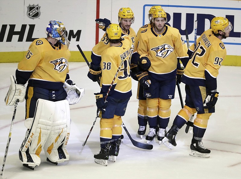 Nashville Predators defenseman Roman Josi (59), is congratulated after scoring an empty-net goal against the Arizona Coyotes during the third period of Tuesday night's game in Nashville. The Predators won 5-2.
