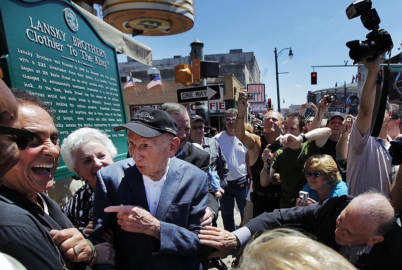 FILE - In this Aug. 14, 2011 file photo, Memphis DJ George Klein, left, jokes with Lansky Brothers founder Bernard Lansky, second from left, "Clothier to the King" during the unveiling of a new plaque to mark the original location of the historic clothing store on Beale St. in Memphis, Tenn. Elvis Presley's longtime friend and radio personality George Klein has died at age 83. Presley's former wife, Priscilla Presley, told The Associated Press that Klein died Tuesday, Feb. 5, 2019, at hospice in Memphis. (Jim Weber/The Commercial Appeal via AP, File)

