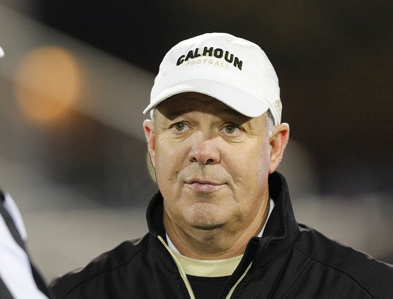 Calhoun football coach Hal Lamb talks with officials before the Yellow Jackets' home playoff game against Jenkins in November 2018. Lamb retired from coaching after 21 highly successful seasons leading the program. / Staff photo by Doug Strickland