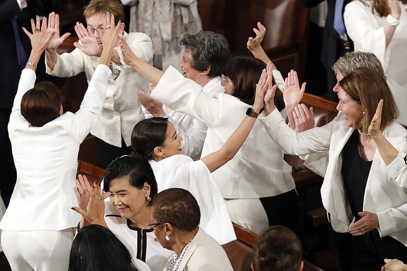 Women members of Congress, including Rep. Alexandria Ocasio-Cortez, D-N.Y., center, cheer after President Donald Trump acknowledges women in new jobs and more women in Congress during his State of the Union address Tuesday. (AP Photo/J. Scott Applewhite)