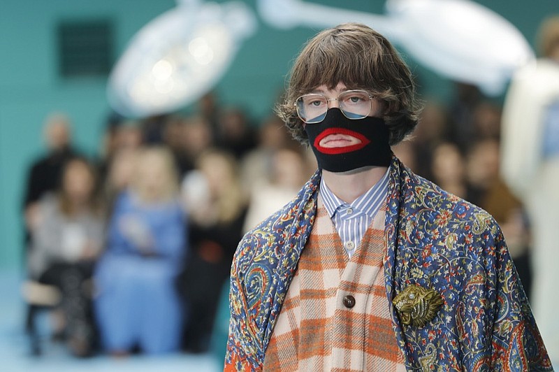 FILE - In this Feb. 21, 2018, file photo, a model wears a creation as part of the Gucci women's Fall/Winter 2018-2019 collection, presented during the Milan Fashion Week, in Milan, Italy. Gucci, which designed this face warmer, reminiscent of blackface prompted an instant backlash from the public and forced the company to apologize publicly on Wednesday, Feb. 6, 2019. (AP Photo/Antonio Calanni, File)

