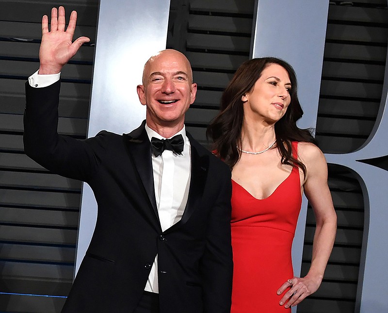 Jeff Bezos, left, and his former wife MacKenzie arrive to the Vanity Fair Oscar party in Beverly Hills, Calif., last March. (Axel Koester/The New York Times)