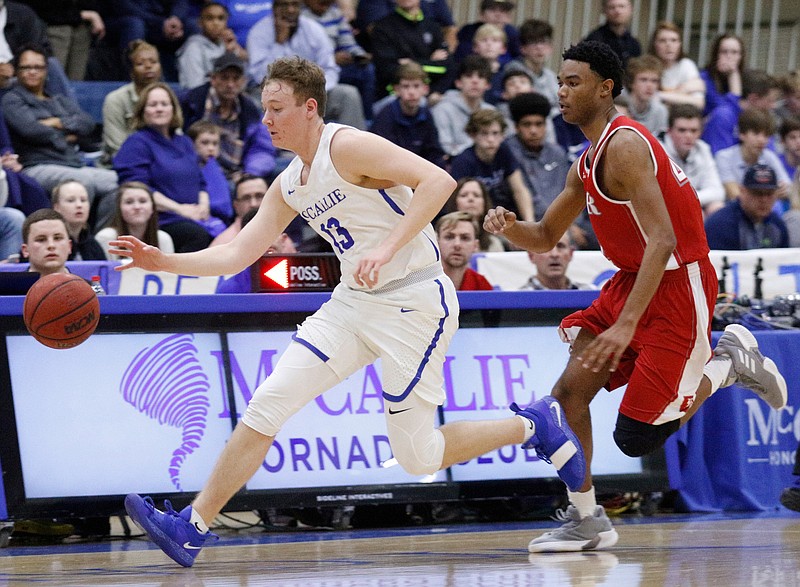 McCallie's Tanner Shulman dribbles out ahead of Baylor's Mekos Baker during their prep basketball game at McCallie School on Friday, Feb. 8, 2019, in Chattanooga, Tenn. 