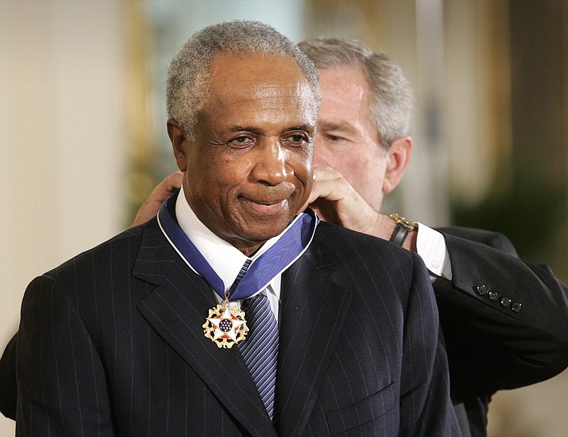 President George W. Bush awards baseball legend Frank Robinson the Presidential Medal of Freedom Award in the East Room of the White House in Washington, D.C., on Nov. 9, 2005. Robinson died Wednesday. He was 83.