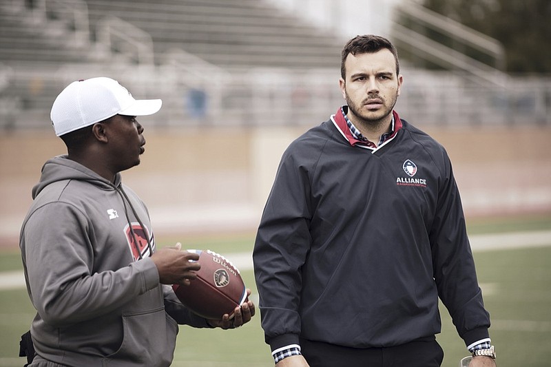 Charlie Ebersol, CEO and co-founder of the Alliance of American Football, right, walks on the field next to Darwin Beacham, San Antonio Commanders equipment manager, on Jan. 22 in San Antonio.