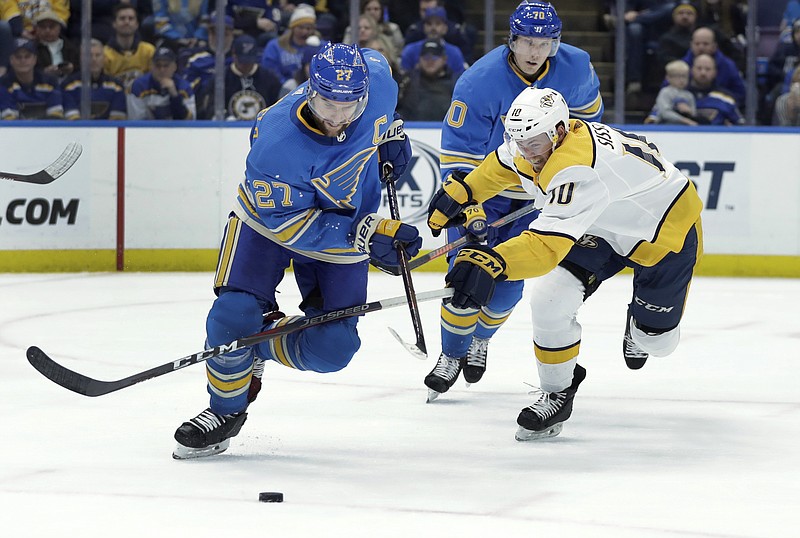 The Nashville Predators' Colton Sissons, right, and the St. Louis Blues' Alex Pietrangelo, left, chase a loose puck during the third period of Saturday's game in St. Louis, which the Blues won 3-2.