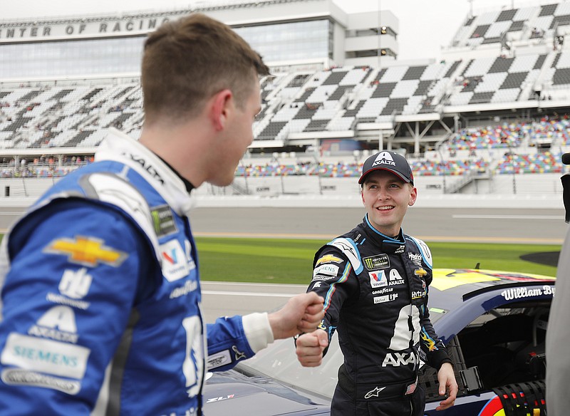 AP photo by Terry Renna / NASCAR Cup Series driver Alex Bowman, left, congratulates Hendrick Motorsports teammate William Byron after their Daytona 500 qualifying runs on Feb. 10, 2019, at Daytona International Speedway.