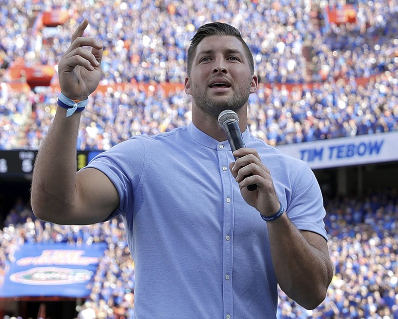 Former University of Florida football player Tim Tebow speaks to fans after he was inducted into the Ring of Honor at Florida Field during the Gators' game against LSU in October 2018. Tebow's foundation started the "Night to Shine" prom for people with special needs.