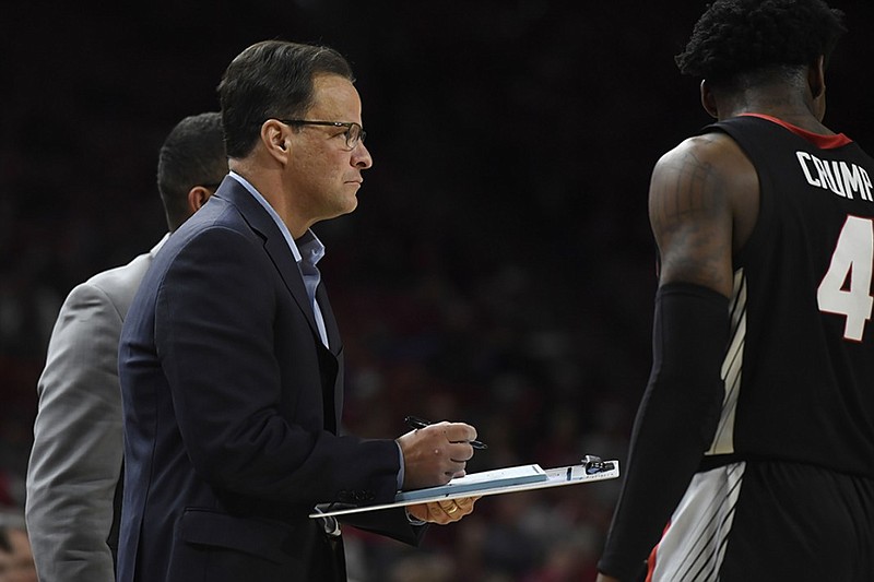 Georgia coach Tom Crean prepares to illustrate a play on the sideline during the Bulldogs' game at Arkansas on Jan. 29 as junior guard Tyree Crump comes off the court. Crump's mother was unhappy with comments Crean made about his players after their loss Saturday to Ole Miss.