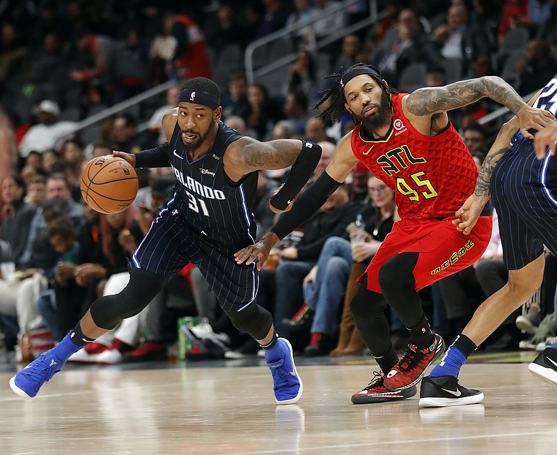 Orlando Magic guard Terrence Ross drives past Atlanta Hawks forward DeAndre' Bembry during the second half of Sunday night's game in Atlanta. Orlando won 124-108.