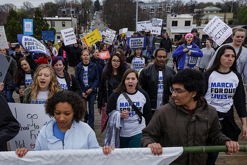 Demonstrators march across the Walnut Street Bridge during the March for Our Lives on Saturday, March 24, 2018, in Chattanooga, Tenn. Thousands of demonstrators marched locally in solidarity with national protests against gun violence spurred by last month's school shooting in Parkland, Fla.