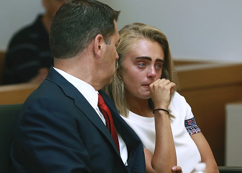 n a Thursday, Aug. 3, 2017 file photo, Michelle Carter awaits her sentencing in a courtroom in Taunton, Mass., for involuntary manslaughter for encouraging Conrad Roy III to kill himself in July 2014. Prosecutors are asking a judge to order Michelle Carter to begin serving her 15-month jail sentence for encouraging her suicidal boyfriend to kill himself. Michelle Carter will appear in court Monday, Feb. 11, 2019 for a hearing to consider prosecutors' request. (Matt West/The Boston Herald via AP, Pool, File)