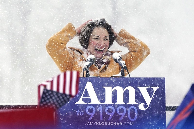 U.S. Sen. Amy Klobuchar wipes snow from her hair after announcing she is running for president of the United States, at Boom Island Park, Sunday, Feb. 10, 2019, in Minneapolis. Klobuchar joined the growing group of Democrats jostling to be president and positioned herself as the most prominent Midwestern candidate in the field, as her party tries to win back voters in a region that helped put Donald Trump in the White House. (Anthony Souffle/Star Tribune via AP)