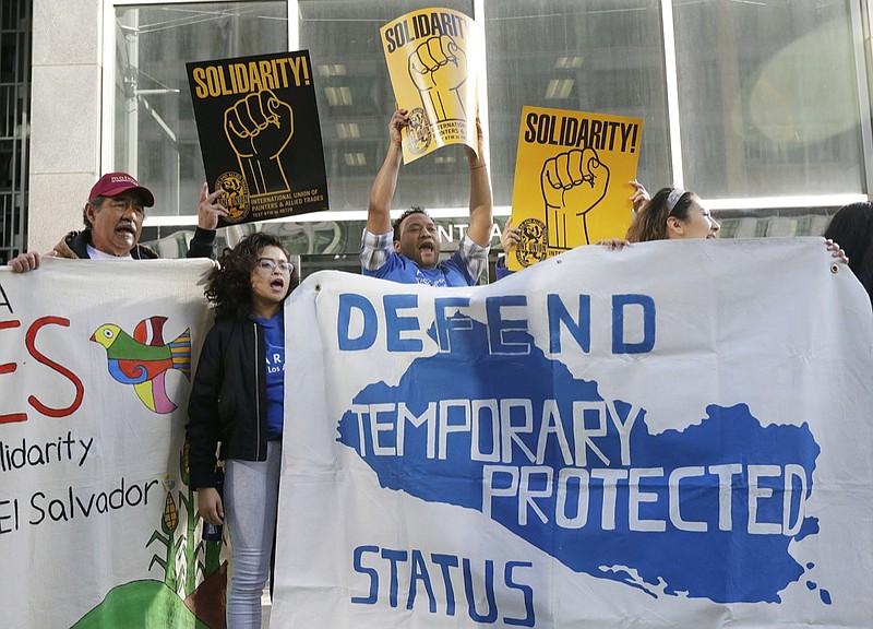 FILE - In this March 12, 2018 file photo, supporters of temporary protected status of immigrants cheer as they hold signs and banners with the outline of El Salvador at a rally at a federal courthouse in San Francisco. (AP Photo/Jeff Chiu, File)

