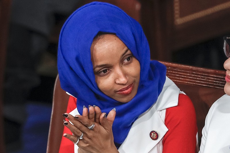 FILE - In this Feb. 5, 2019, file photo, Rep. Ilhan Omar, D-Minn., listens to President Donald Trump's State of the Union speech, at the Capitol in Washington. Omar "unequivocally" apologized Monday, Feb. 11, 2019, for tweets suggesting that members of Congress support Israel because they are being paid to do so, which drew bipartisan criticism and a rebuke from House Speaker Nancy Pelosi. (AP Photo/J. Scott Applewhite, File)

