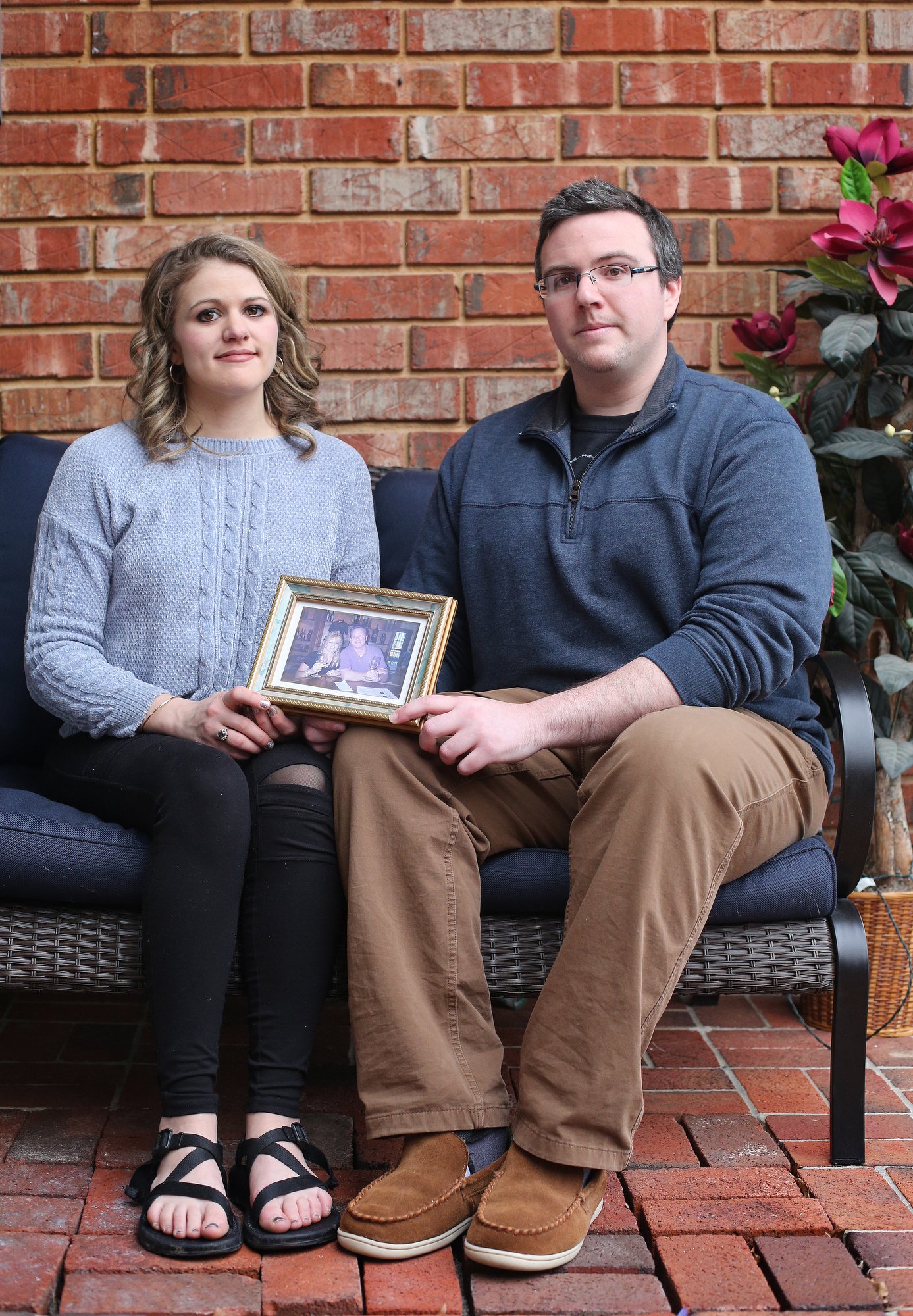 Siblings, Alaina Marinello and Christopher Marinello are photographed with a photo of their mom and dad, Lynda and Chris Marinello, Sunday, February 3, 2019 at Alaina's Chattanooga, Tenn., home. Lynda was the passenger in a plane crash in Soddy-Daisy, Tenn., earlier this year. Both Lynda and a family friend, Captain Frank W. Davey, who was the pilot, died in the crash.